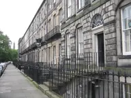 Houses on Fettes Row, Edinburgh New Town, from the pavement: railings, steps to the main doors and steps down to basement flats